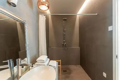 a bathroom with a sink and a shower at Pekarna apartments in Ljubljana