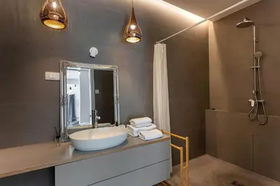 a bathroom with a white sink and a shower at Pekarna apartments in Ljubljana