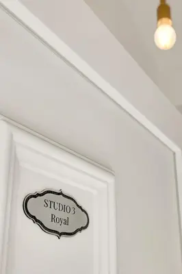 a sign on a door that reads studio royal at Pekarna apartments in Ljubljana