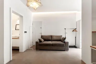 a living room with a couch and a bedroom at Pekarna apartments in Ljubljana