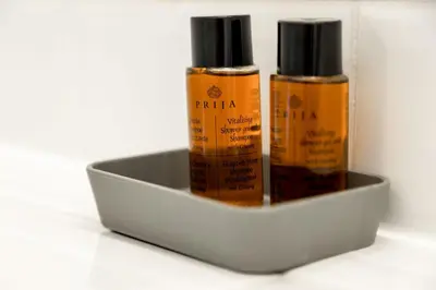 two bottles of essential oils in a metal container at Pekarna apartments in Ljubljana