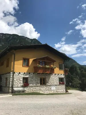 a building with a balcony on the side of it at House Berdnik in Stahovica