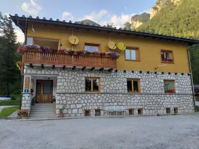 a building with a balcony on top of it at House Berdnik in Stahovica