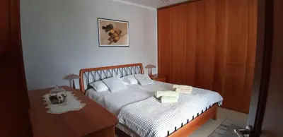 a bedroom with a bed and a table with towels at Apartment Bor in Bovec