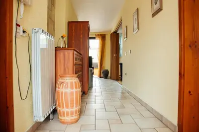 a hallway with an orange vase sitting on the floor at Apartment Bor in Bovec