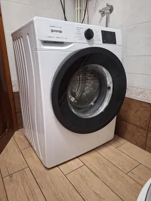 a white washing machine sitting on a floor at Apartment Bor in Bovec