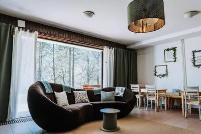 a living room with a couch and a large window at TUBA Apartments in Bohinj