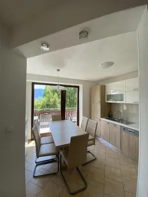 a kitchen and dining room with a table and chairs at Apartma Logar in Kobarid