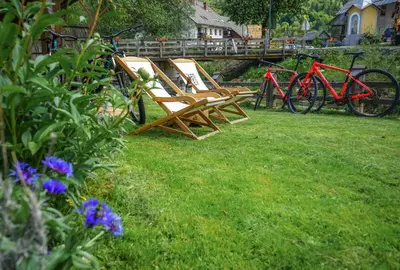 two chairs sitting on the grass in a yard at Hike & Bike Chalet in Bohinj