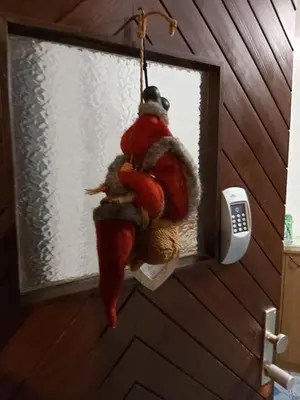 a santa claus ornament hanging from a window at Apartments & Rooms Florjana in Bled