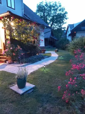a house with flowers on the side of it at Apartments & Rooms Florjana in Bled