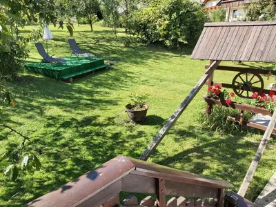 a garden with two chairs and a hammock in the grass at Apartments & Rooms Florjana in Bled