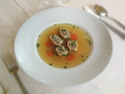 a bowl of soup with oysters on a table at Šiker B&B Hotel in Pernica