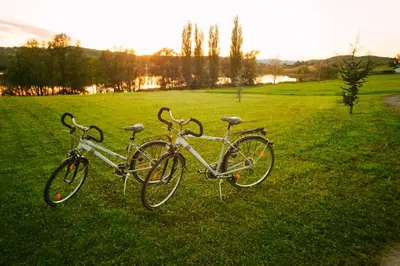two bikes parked in the grass in a field at Šiker B&B Hotel in Pernica