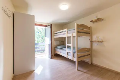 a bedroom with two bunk beds and a window at Dolar Rooms in Bled