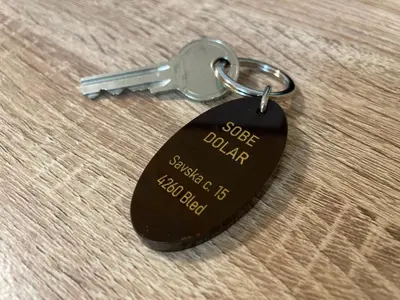 a key chain with the words super dollar on it at Dolar Rooms in Bled