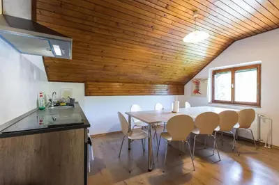 a kitchen and dining room with a table and chairs at Dolar Rooms in Bled