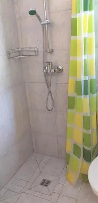 a bathroom with a shower with a shower curtain at Relax in Črni Kal in Črni Kal