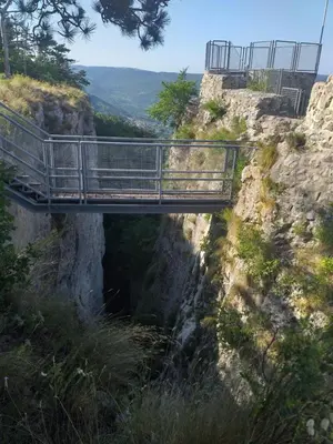 a bridge on the side of a cliff at Relax in Črni Kal in Črni Kal
