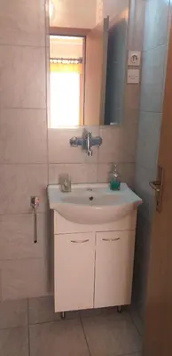 a bathroom with a sink and a mirror at Relax in Črni Kal in Črni Kal