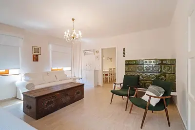 a living room with a couch and a table and chairs at Pr`Mružo apartmaji in Bohinj