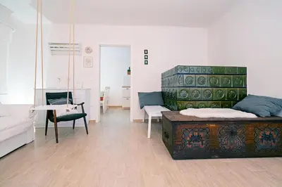 a living room with a couch and a table at Pr`Mružo apartmaji in Bohinj
