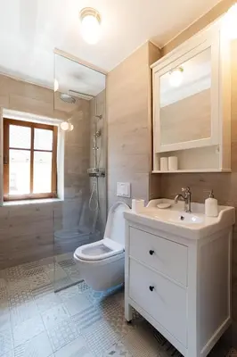 a bathroom with a toilet and a sink and a shower at Pr`Mružo apartmaji in Bohinj