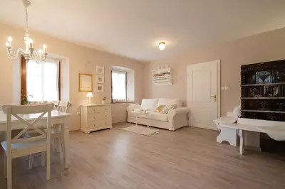 a living room with a couch and a table at Pr`Mružo apartmaji in Bohinj