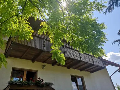 a balcony on the side of a house at Apartmaji Volf in Zgornje Gorje