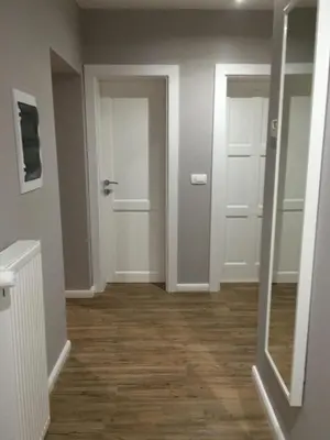 an empty hallway with a door and a mirror at Apartma Lilly in Bled