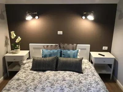 a bedroom with a large bed with two night stands at Apartma Lilly in Bled