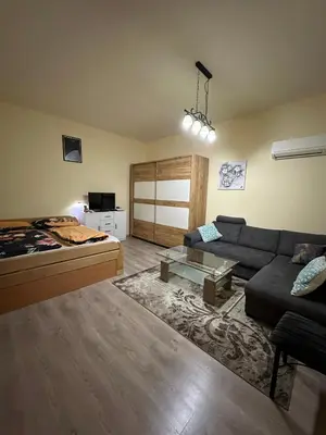 a living room with a couch and a bed at Alpino in Ljubljana