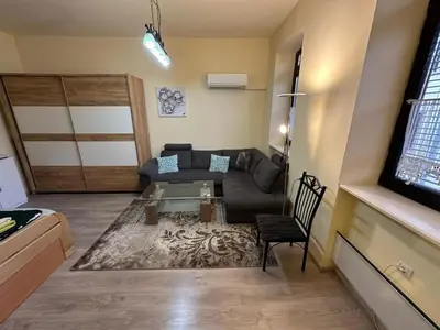 a living room with a couch and a table at Alpino in Ljubljana