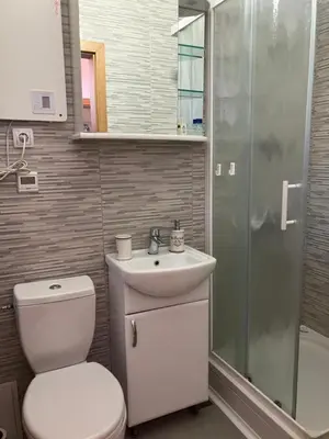 a bathroom with a toilet and a sink and a shower at Alpino in Ljubljana