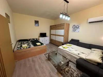 a living room with a bed and a couch at Alpino in Ljubljana