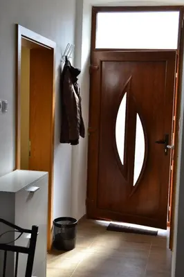 a room with a wooden door with a window at Alpino in Ljubljana