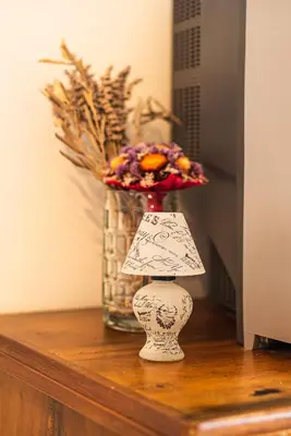 a vase on a table with a vase with flowers at Valley View Holiday Home with Sauna Mrak in Slappe dʼIdria