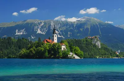 a church on an island in the middle of a lake at Hostel Bled Paradise Slovenia in Bled-Rečica