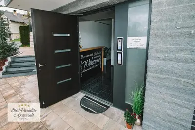 a door to a building with a sign on it at Hostel Bled Paradise Slovenia in Bled-Rečica