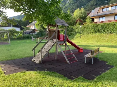 a playground with a slide in a yard at Apartments Rikli Rodine near Bled in Rodine