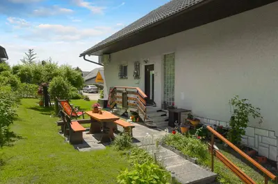 a patio with benches and a table outside of a house at Apartments Rikli Rodine near Bled in Rodine