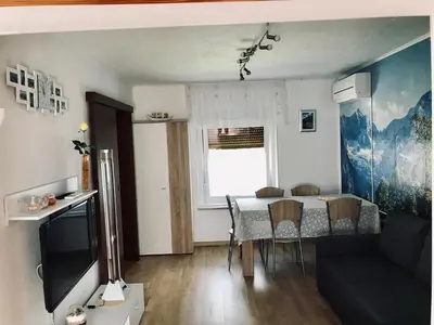 a living room with a table and a couch at Apartma Evi in Žaga