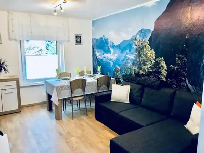 a living room with a couch and a dining table at Apartma Evi in Žaga