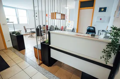 a salon with a reception desk in a room at Sobe Rooms Nataly in Sežana