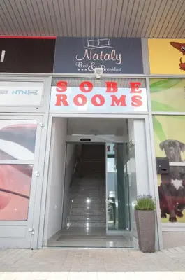 a door to a restaurant with a sign on it at Sobe Rooms Nataly in Sežana