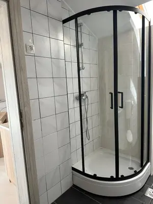 a shower with a glass door in a bathroom at Apartments and Wellness Ščavničar in Ljutomer