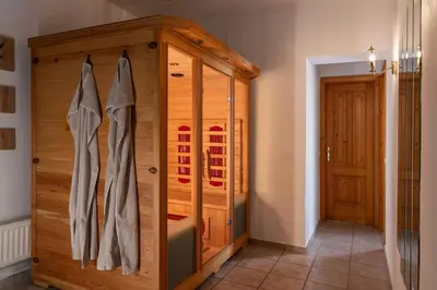 a large wooden cabinet in a room with a door at Vila Grad Bled - Sauna & Hot tub in Bled
