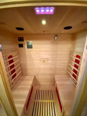 a small sauna with a bench in the middle at Vila Grad Bled - Sauna & Hot tub in Bled