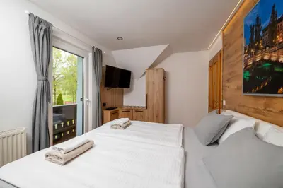 a bedroom with a white bed and a window at Vila Grad Bled - Sauna & Hot tub in Bled