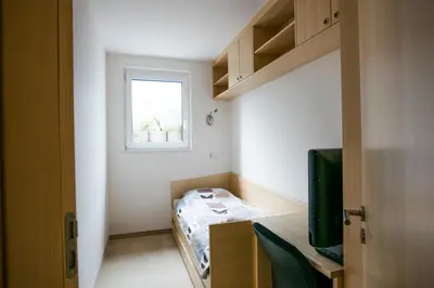 a small room with a bed and a window at Luxury apartment with a nice view in Kranjska Gora in Kranjska Gora